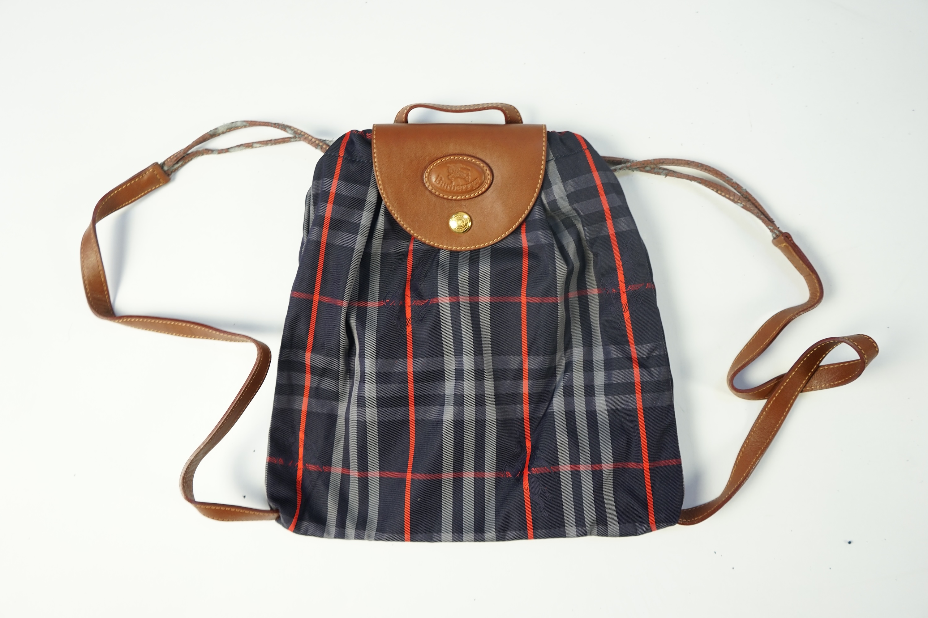 Two tartan canvas with leather trim Burberry bags, one backpack and one bucket bag